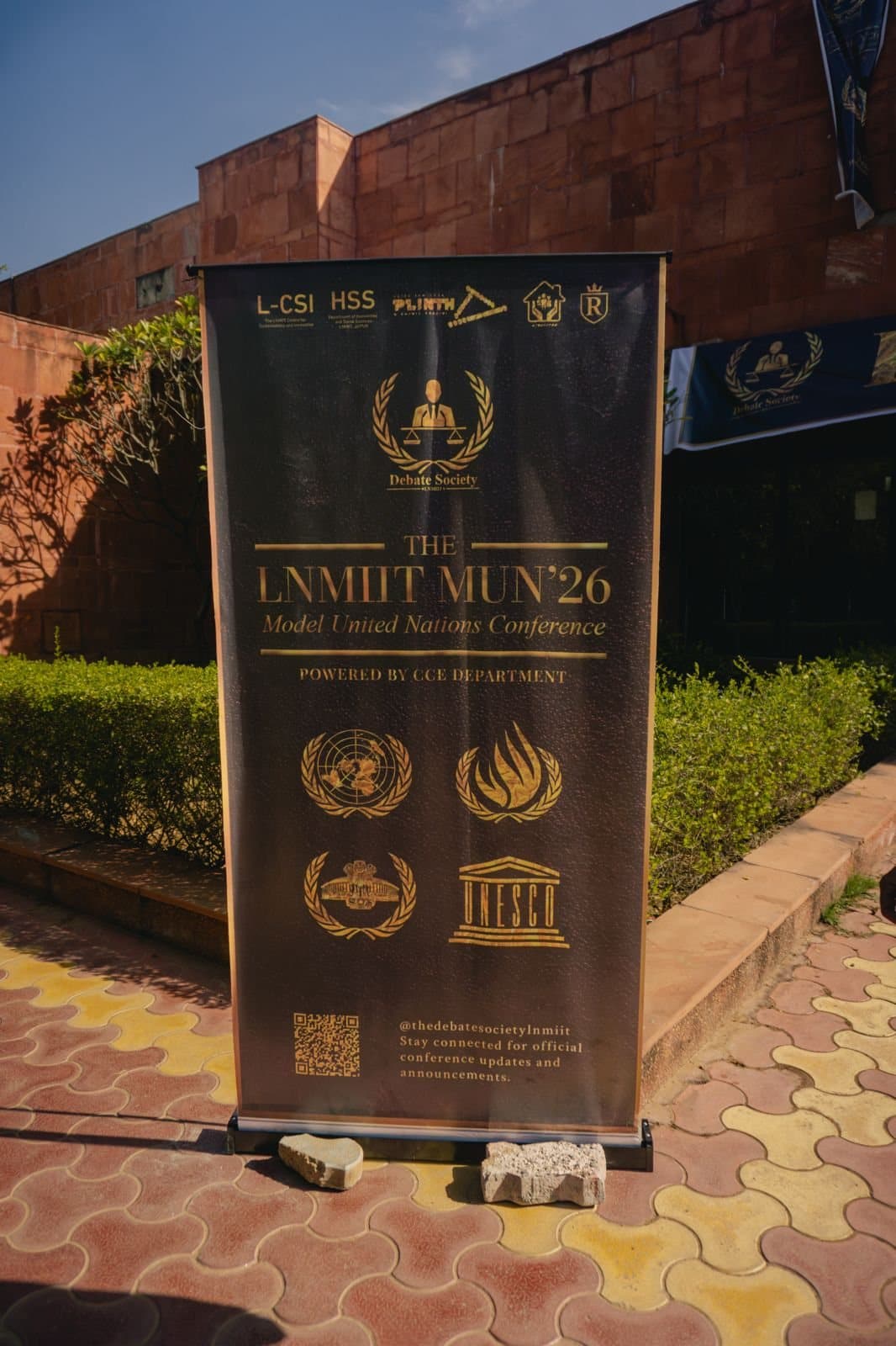 An LNMIIT MUN'26 standee naming the partner departments.